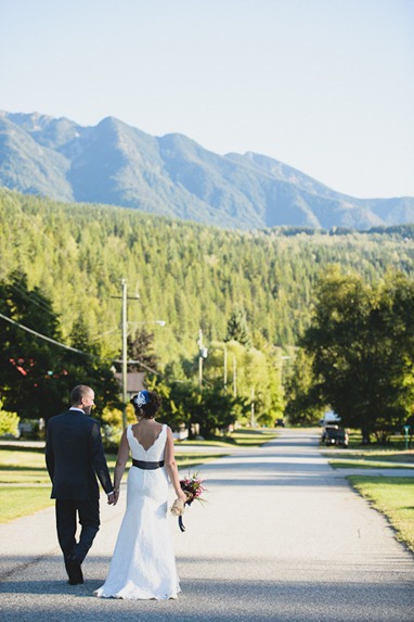 bride and groom walking through silverton bc by kootenay wedding photographer electrify photography