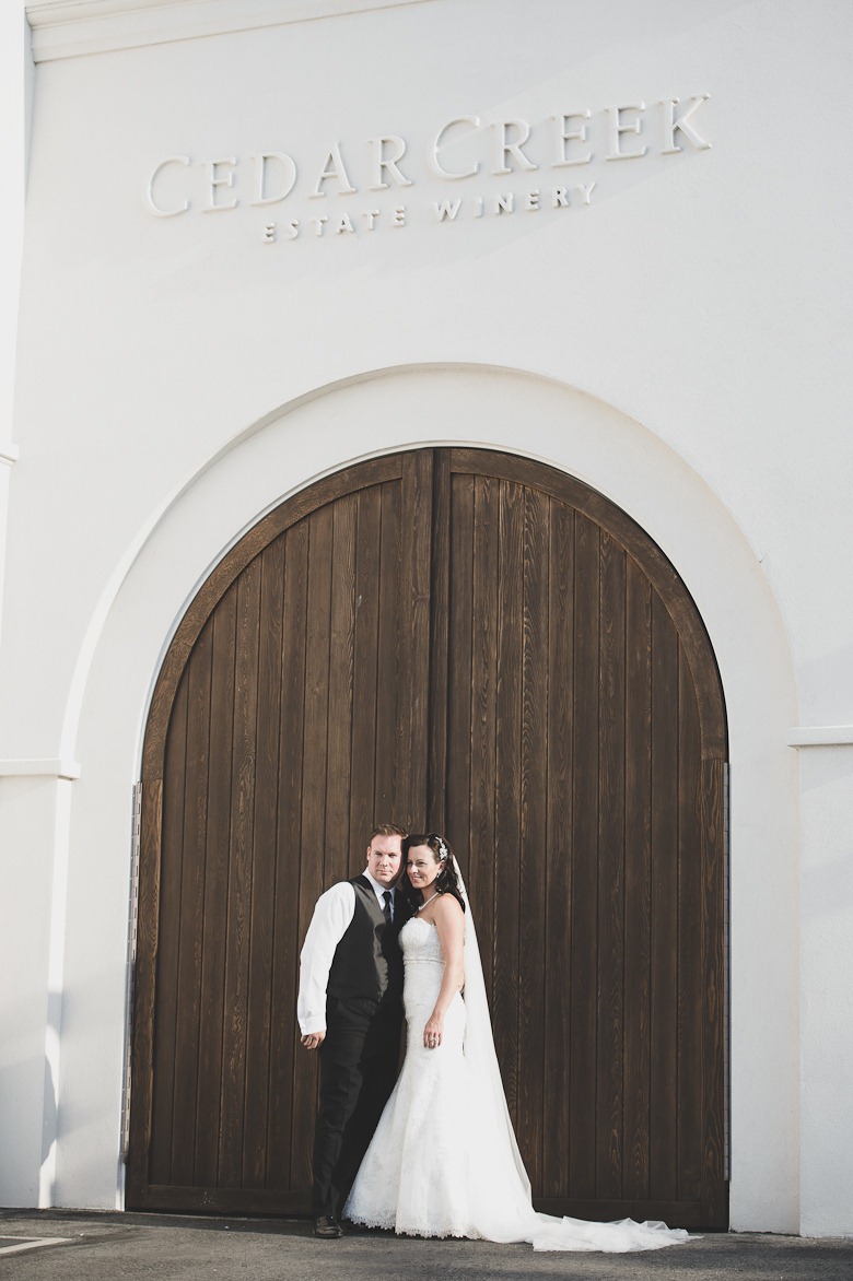 bride and groom at cedar creek winery, vintage okanagan wedding by nelson, kelowna, bc, wedding photographer electrify photography