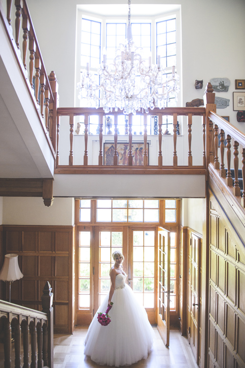Classic beauty bride under chandelier in Blaylock's Mansion, by Nelson BC Kootenay wedding photographer Emilee Zaitsoff of Electrify Photograph