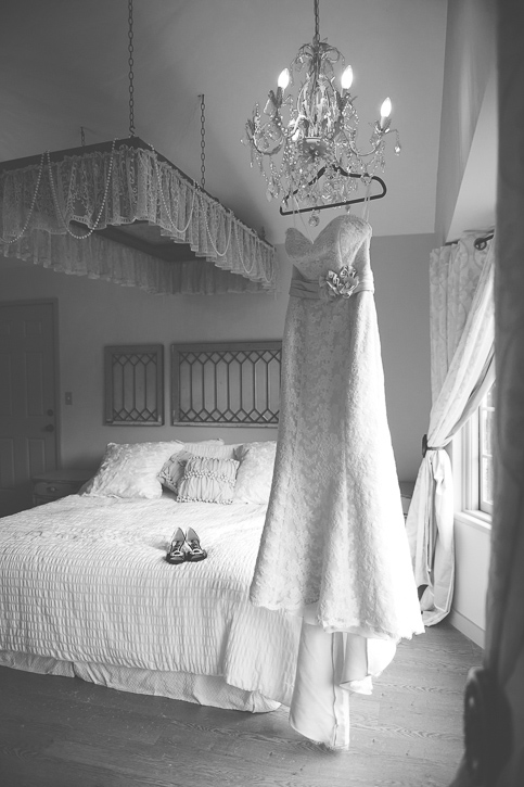 Wedding dress hangs in country chic room at columbia gardens winery, black and white, by Nelson BC Kootenay wedding photographer Emilee Zaitsoff of Electrify Photography
