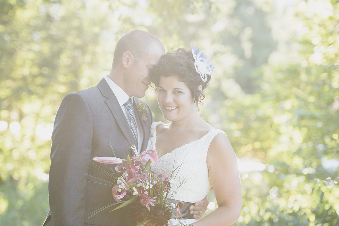 Love and sun flares at rustic Kootenay Wedding by Electrify Photography.