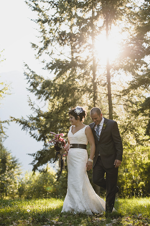 Bride and Groom walking candid at rustic Kootenay Wedding by Electrify Photography.