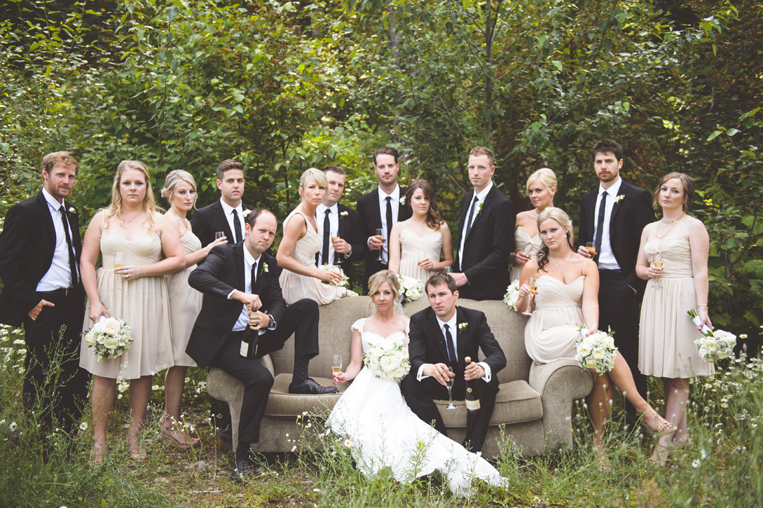 Wedding party champagne toast on couch in forest of flowers at red mountain, rossland, by Nelson BC Kootenay wedding photographer Emilee Zaitsoff of Electrify Photograph