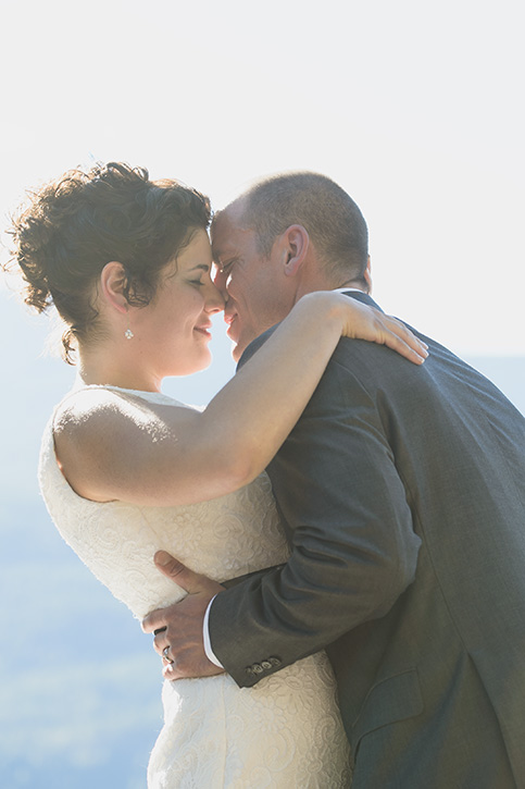 The first kiss at rustic Kootenay Wedding by Electrify Photography.