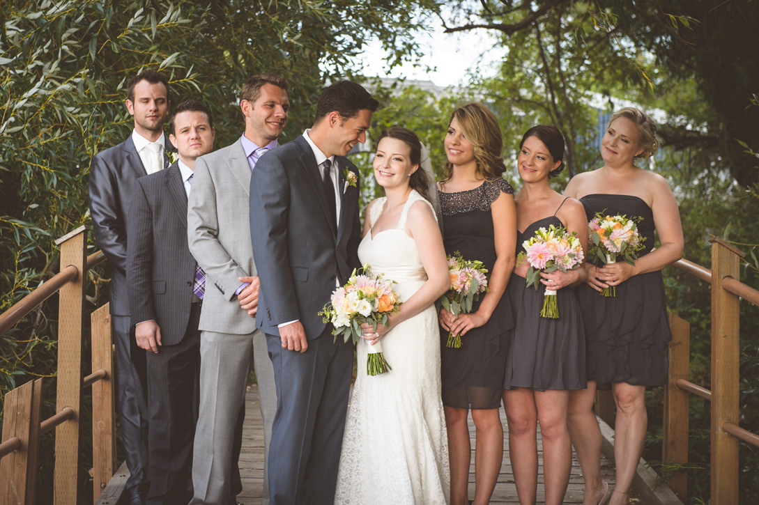 Wedding party on bridge with overhanging trees near Kelowna, BC, Okanagan by Nelson BC Kootenay wedding photographer Emilee Zaitsoff of Electrify Photography