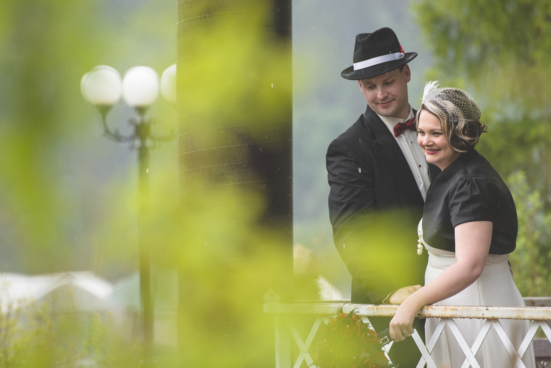 Couple hide in Prestige Resort gazebo from the rain, by Nelson BC Kootenay wedding photographer Emilee Zaitsoff of Electrify Photograph